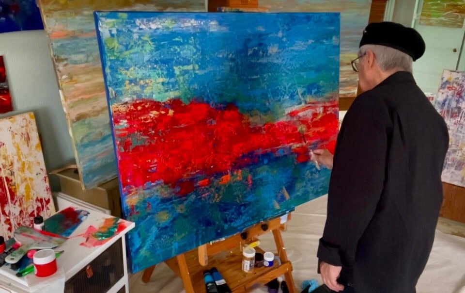 Abstract Artist Gregory Christeas at front of his easel painting